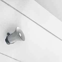 gray megaphone on white surface