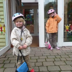 Zwei Kinder stehen vor der geöffneten Kindergarten-Tür